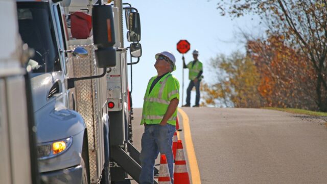 man standing beside parked truck